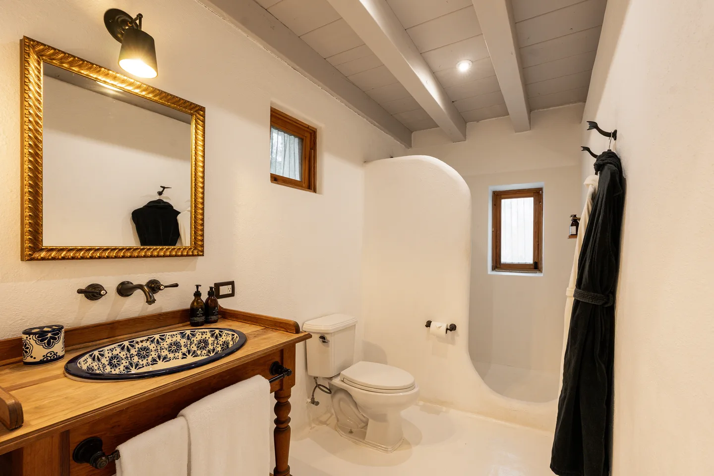 Talavera basin, gilt mirror and curved walk-in shower — NEST Baja